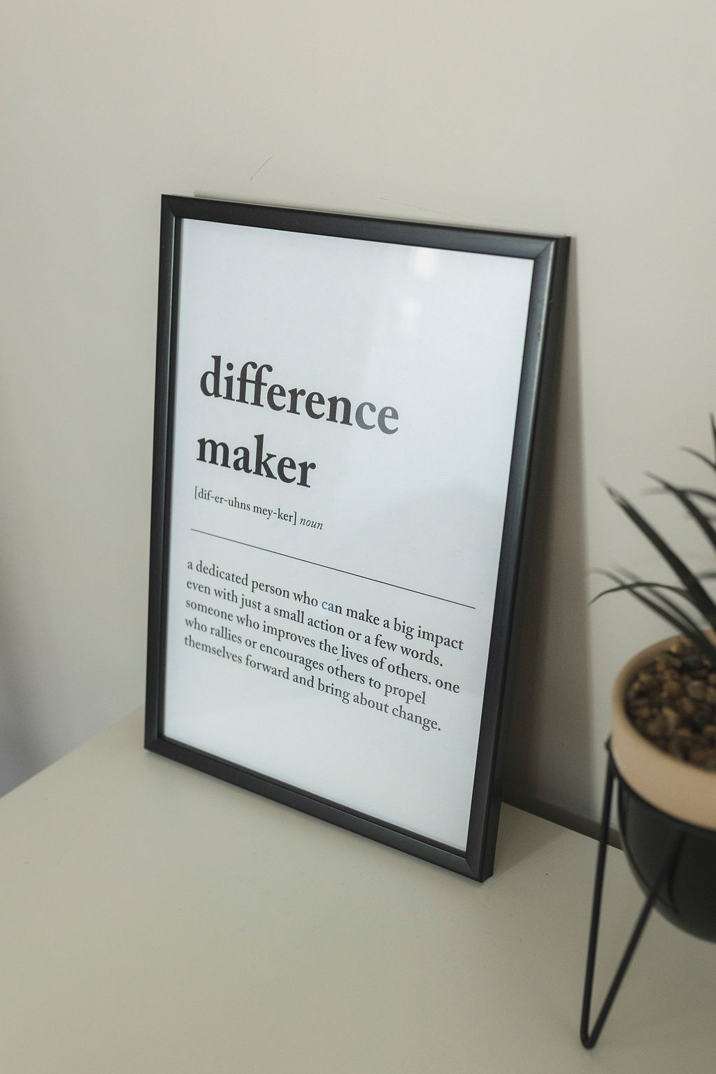 A framed print defining difference maker: a dedicated person who can make a big impact even with just a small action or a few words